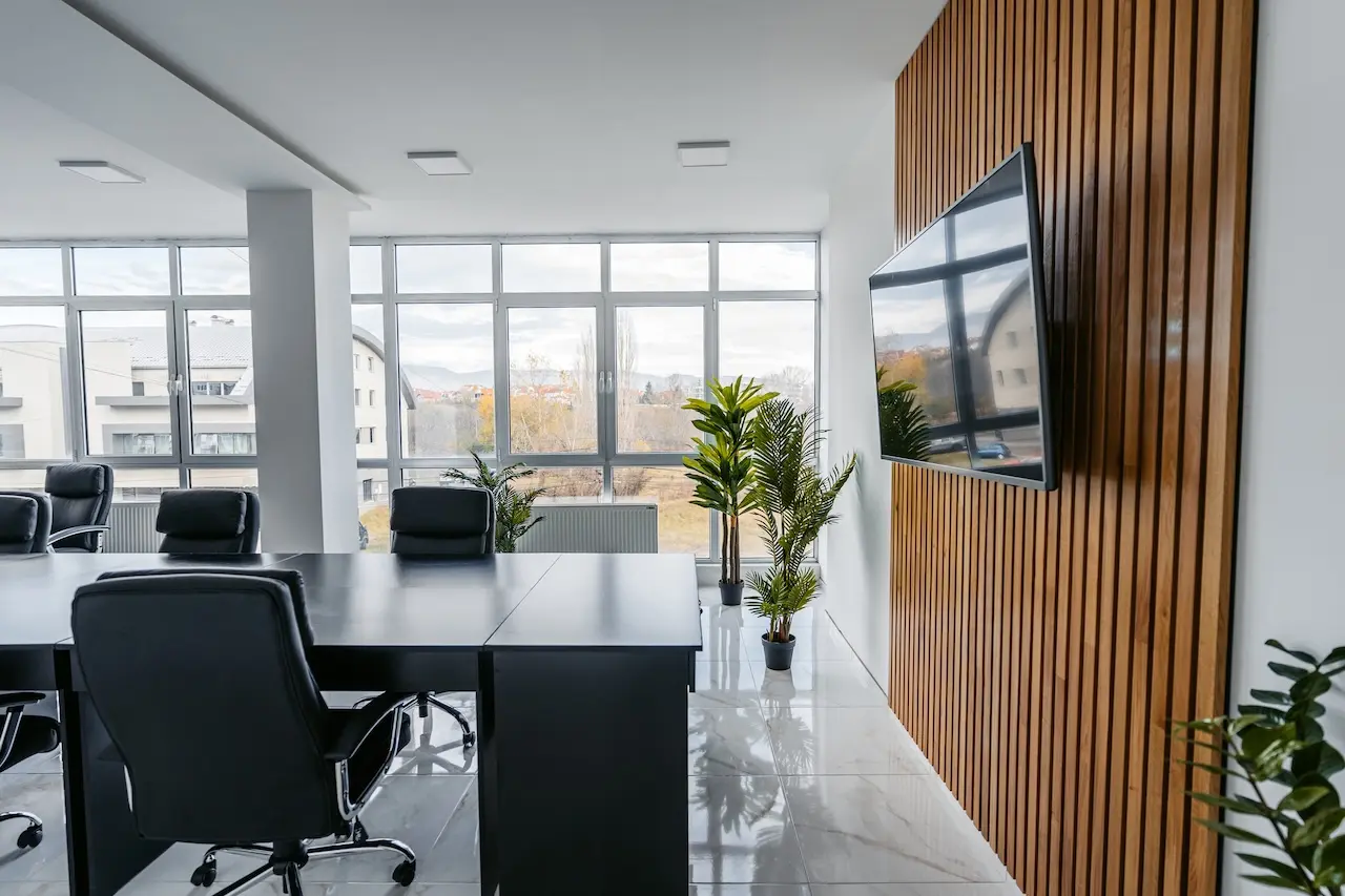 Commercial AV installation with wall-mounted display in a modern office conference room<br />

