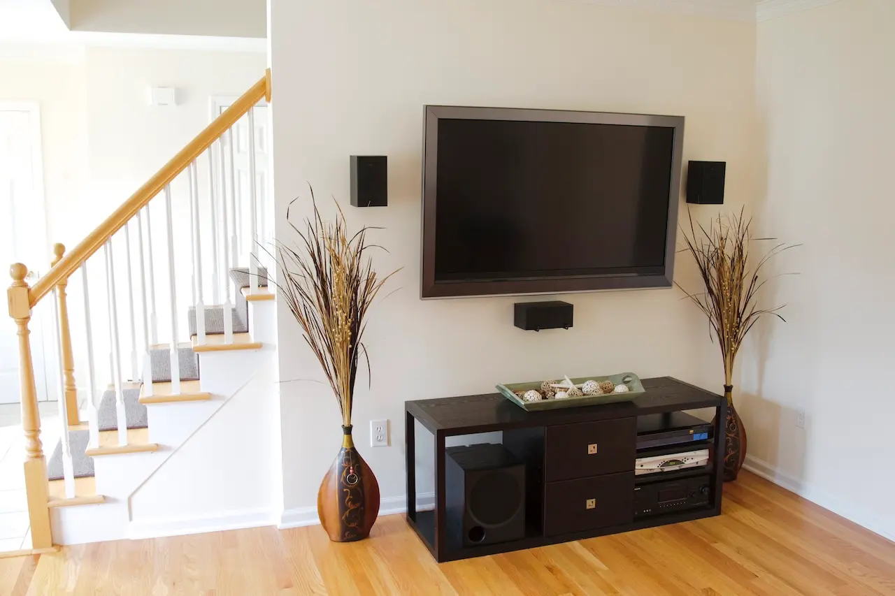 Residential AV solution featuring a clean TV install with surround sound and integrated media console